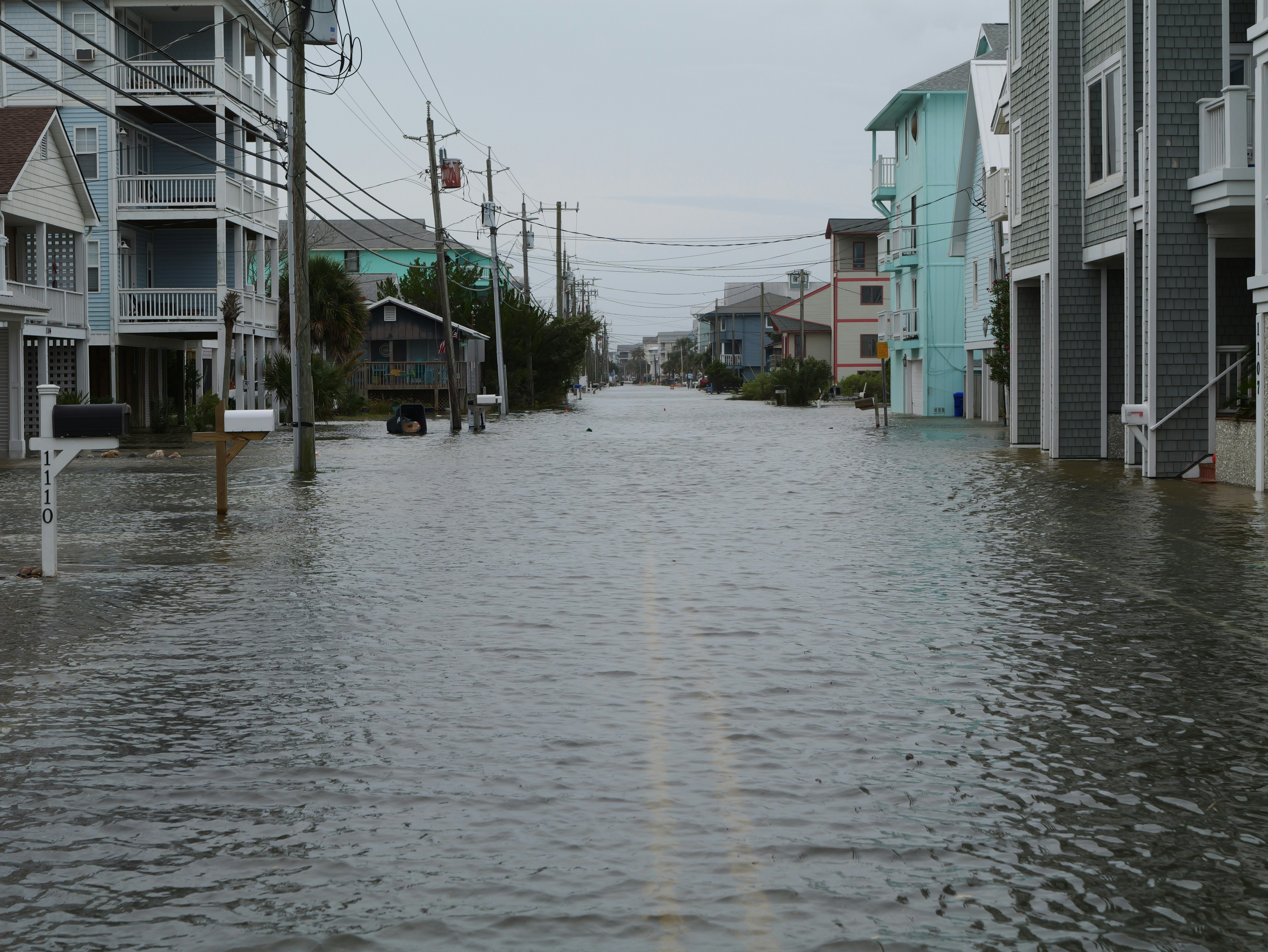 Street flooded with water between houses