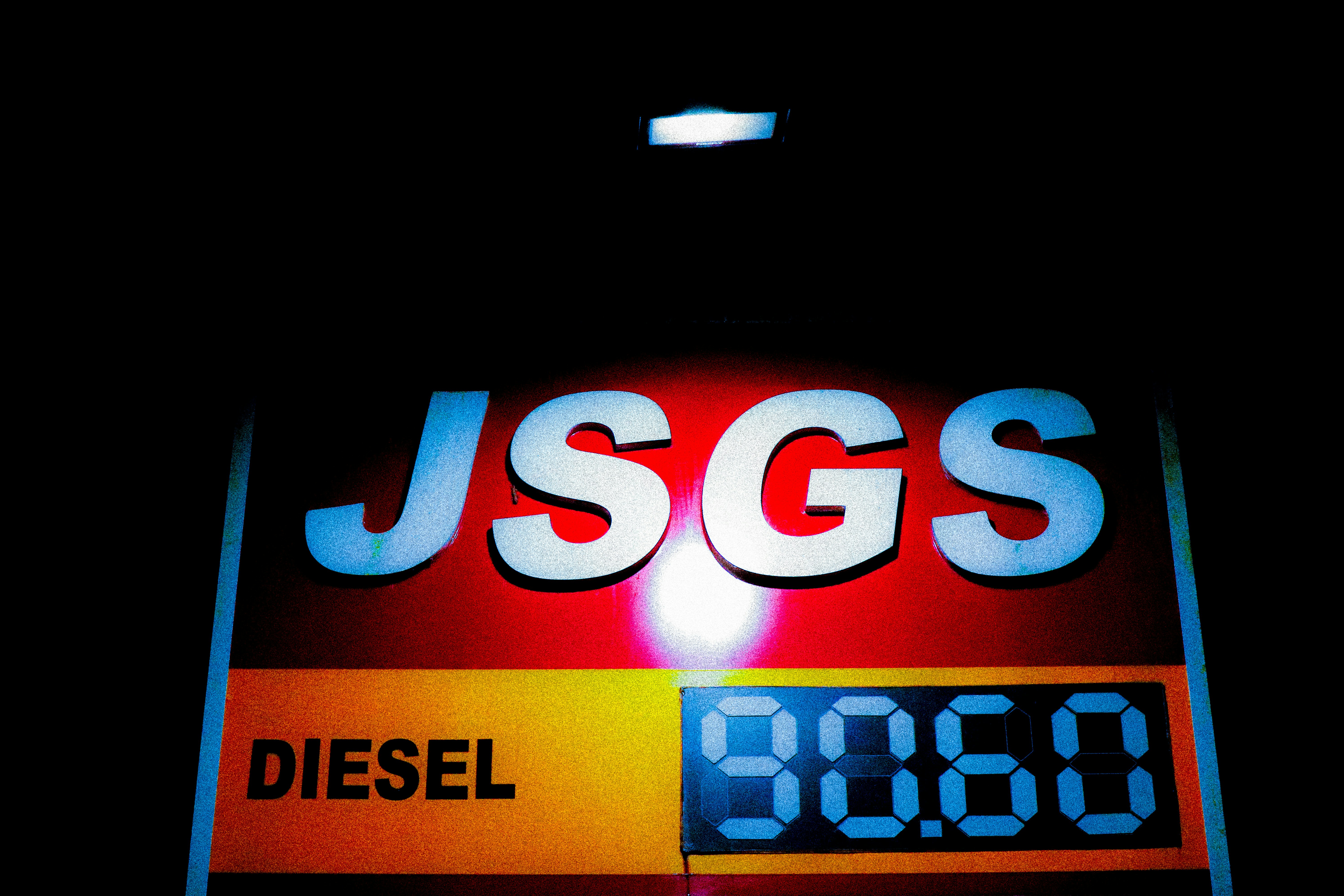 A glowing red sign displaying the text JSGS and the word DIESEL